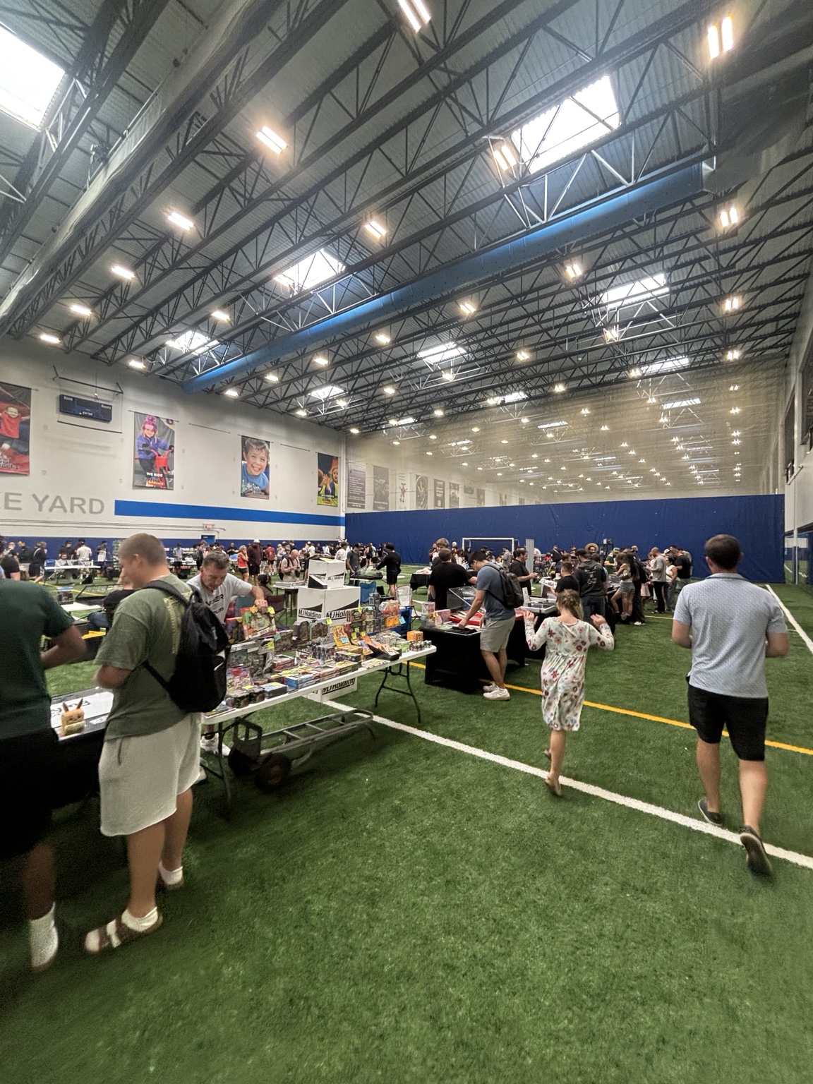 Collectors browsing trading card vendor tables at a card show